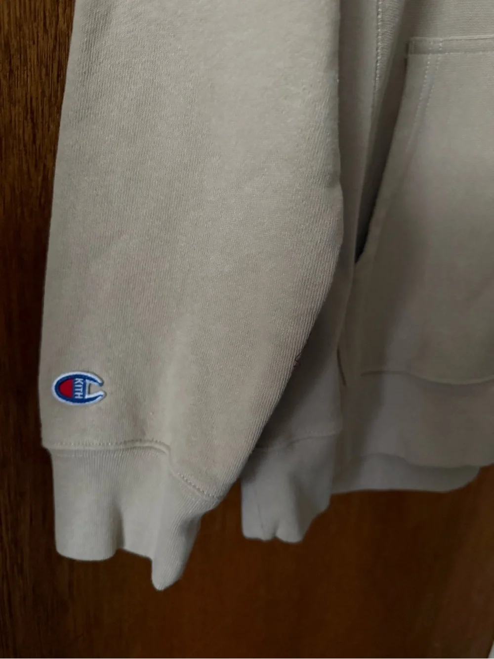 Kith and Champion Collab Beige Hoodie with Multicolor Sleeve Logo